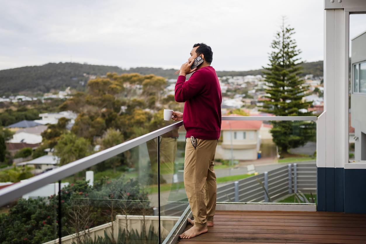 Man on the phone at home with his shoes off